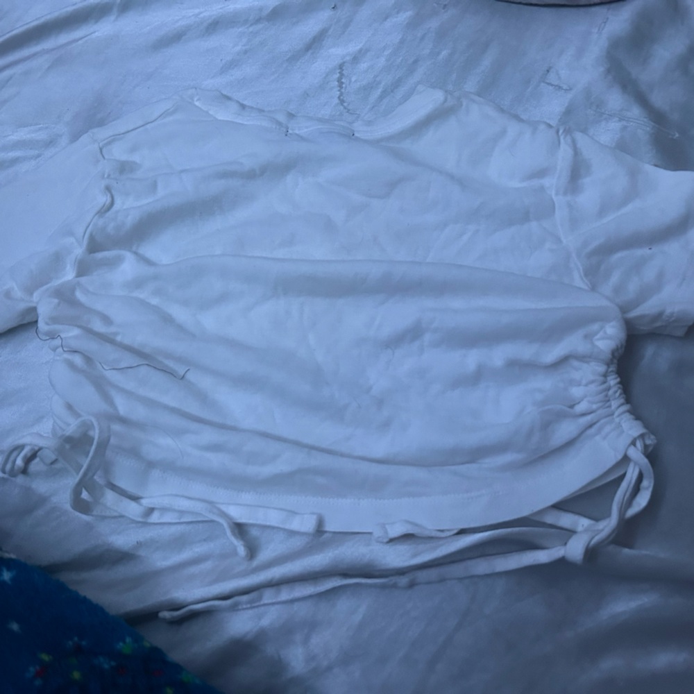 The shirt is adjustable on the sides. Never worn before.